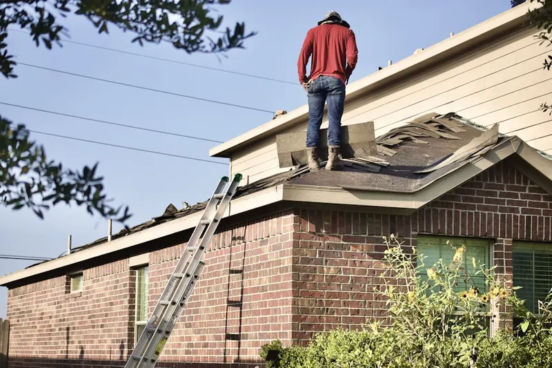 Professional roofer working on a residential roof in Harmony